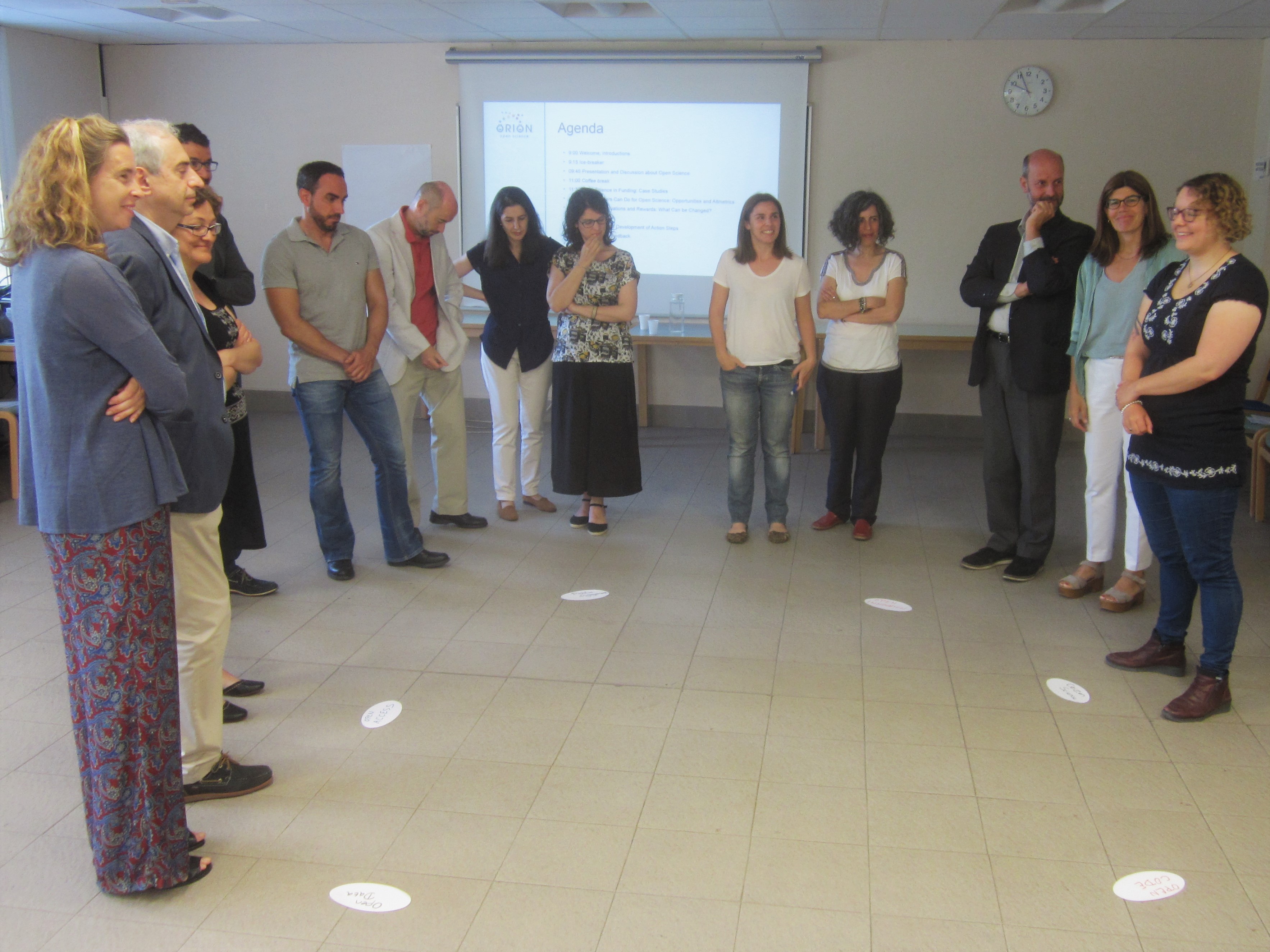 Participants standing in a semi-circle